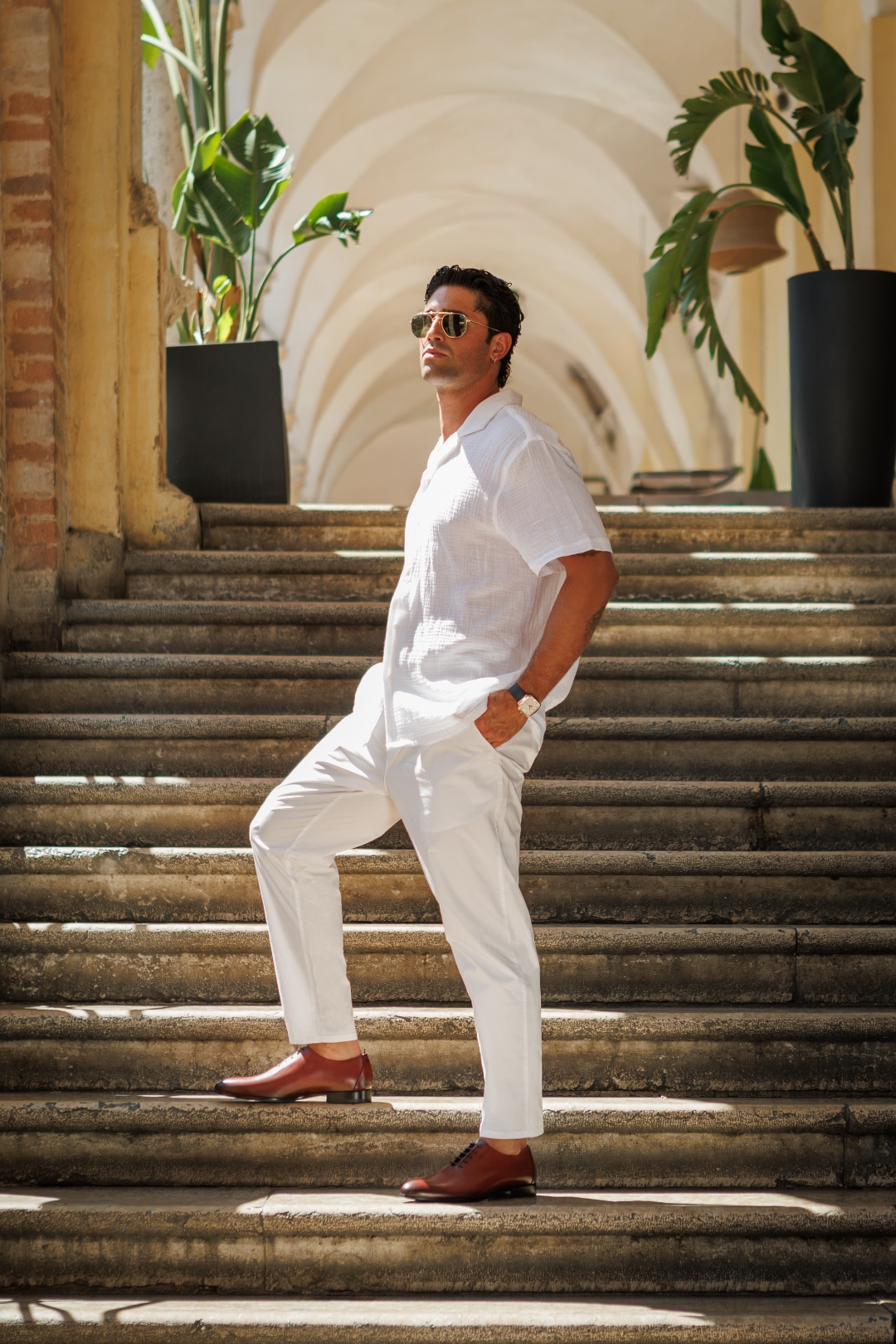 Nunzio Orsini whole-cut Oxford shoes in maroon top grain Italian leather, worn on elegant colonnade steps in Marche, Italy
